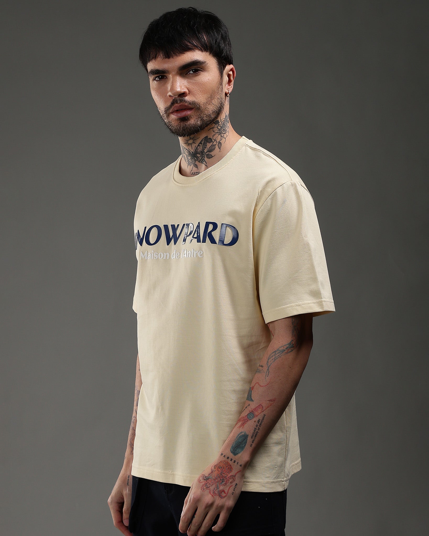 Snowpard Maison de l'Antre Relaxed Tee Beige — back view, bold SNOWPARD chest print