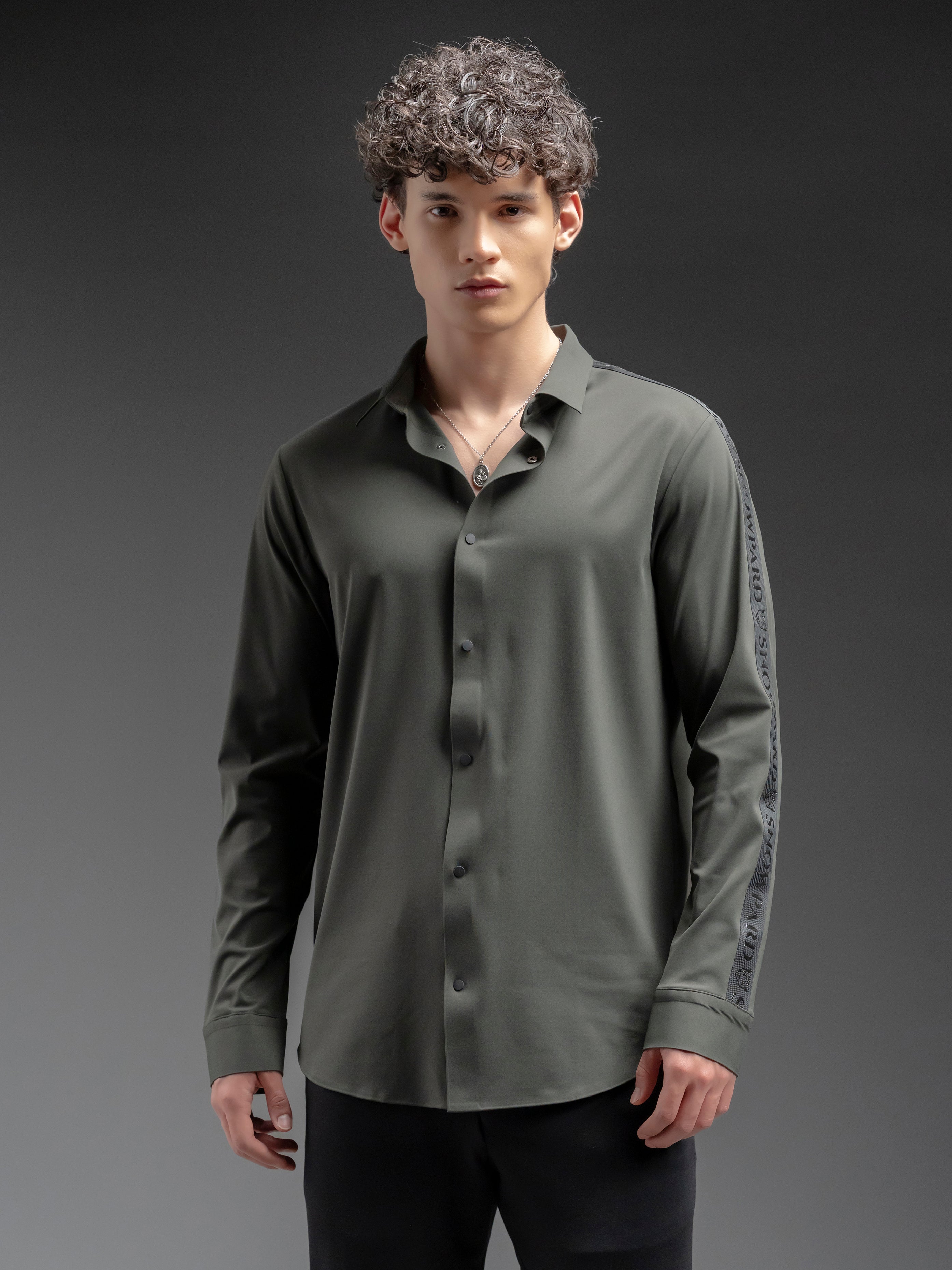 Man wearing a green button-up shirt with long sleeves