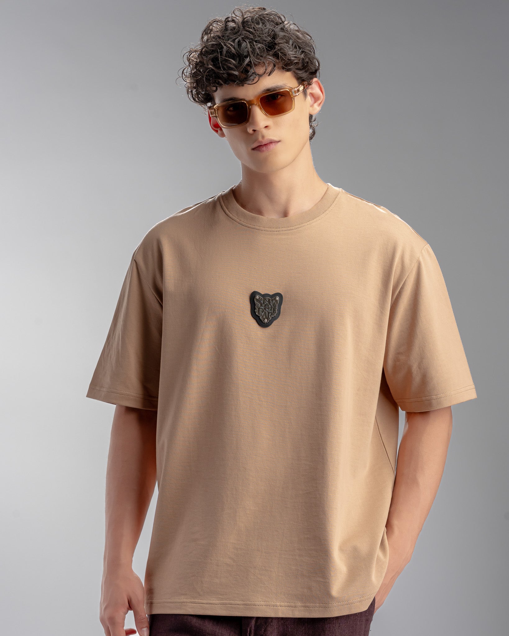 Snowpard Metal Badge Relaxed Tee Sand — front view, men's emblem patch t-shirt India
