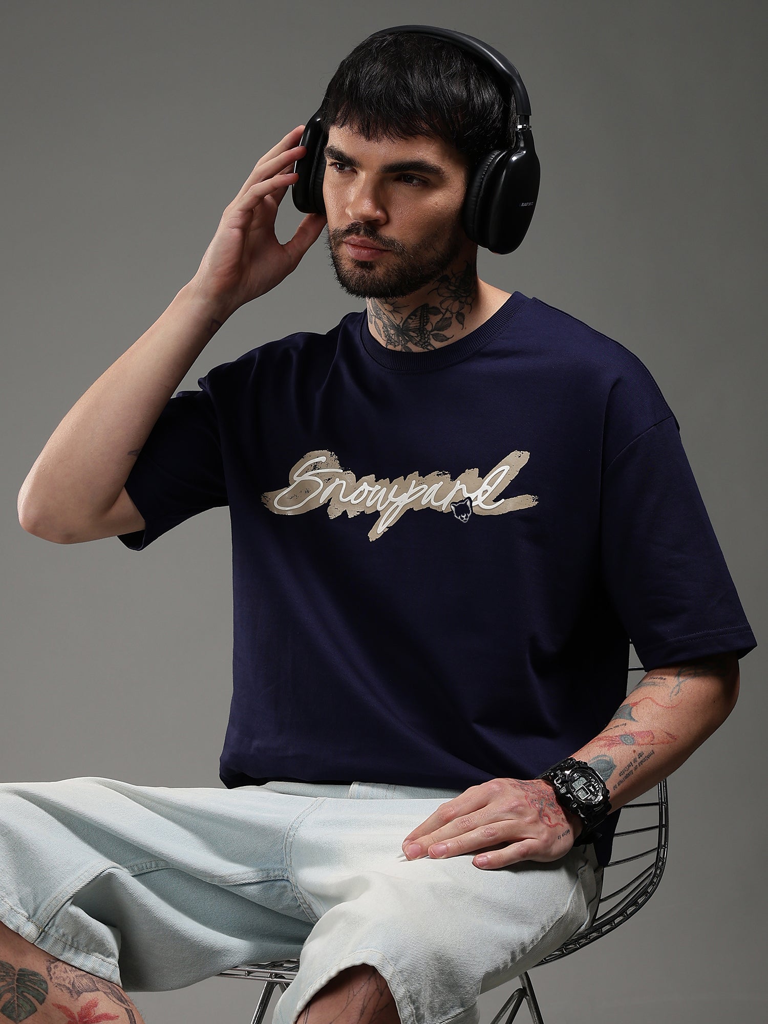 Man wearing a navy blue t-shirt with logo