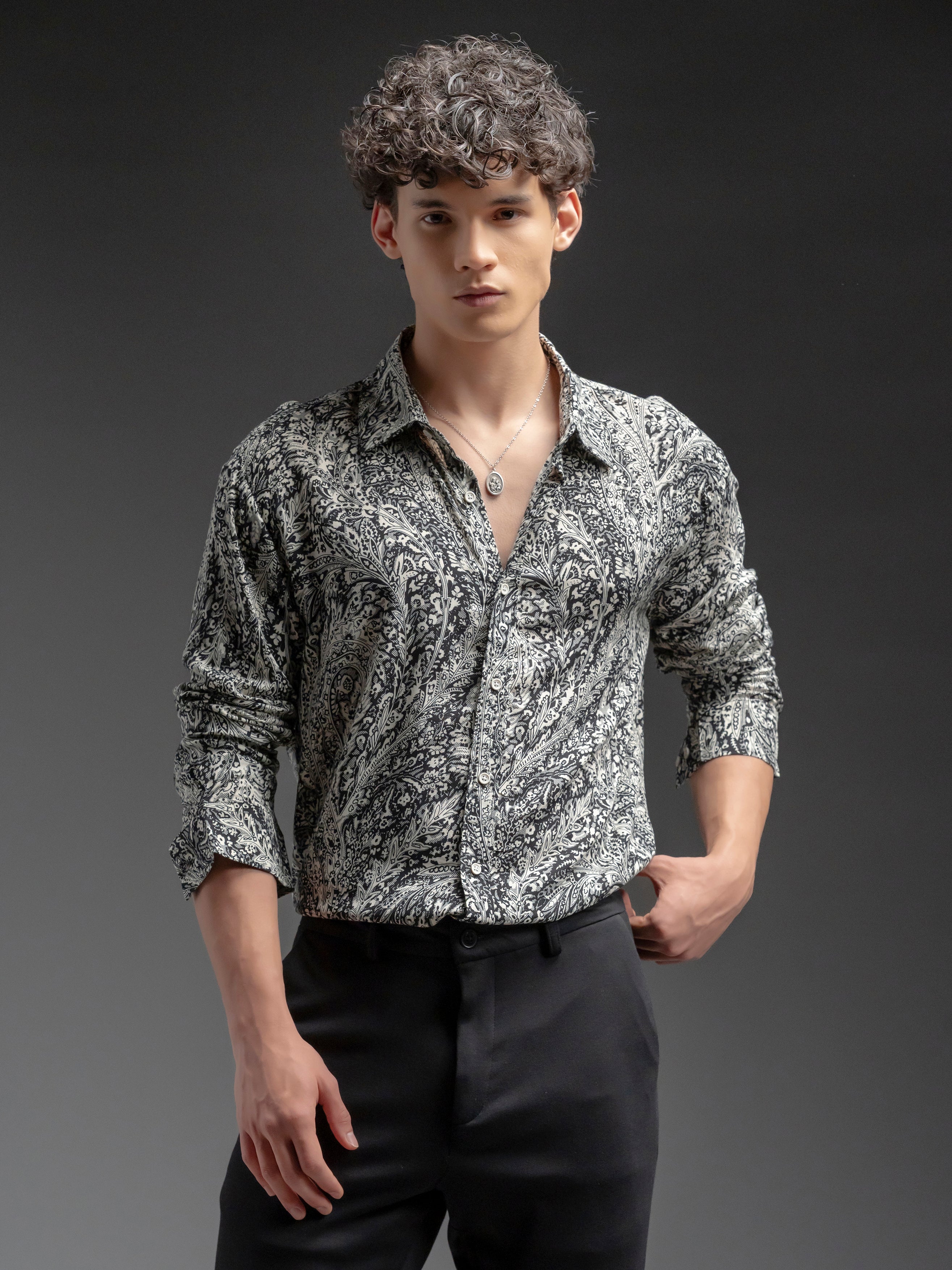 Man wearing a patterned shirt and black pants