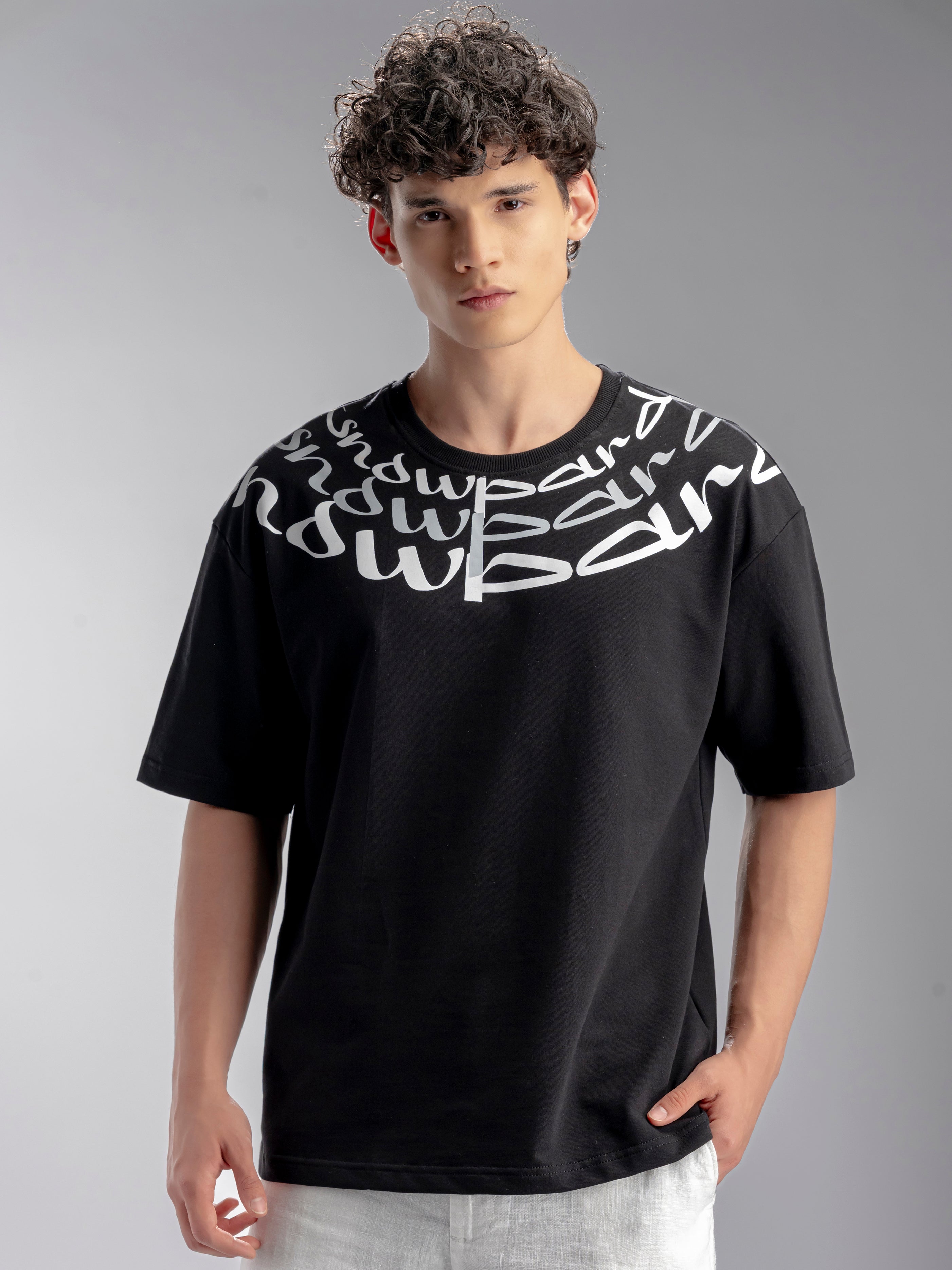 Man wearing a black t-shirt with white text design