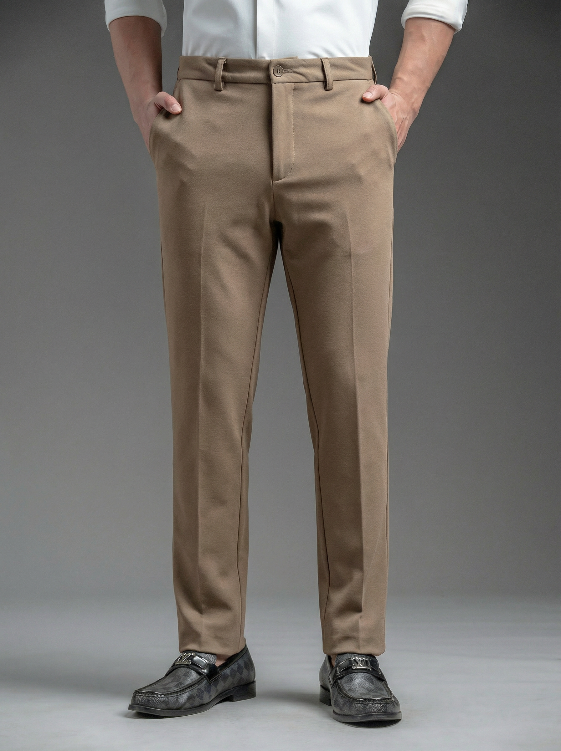 Person wearing beige pants and black shoes