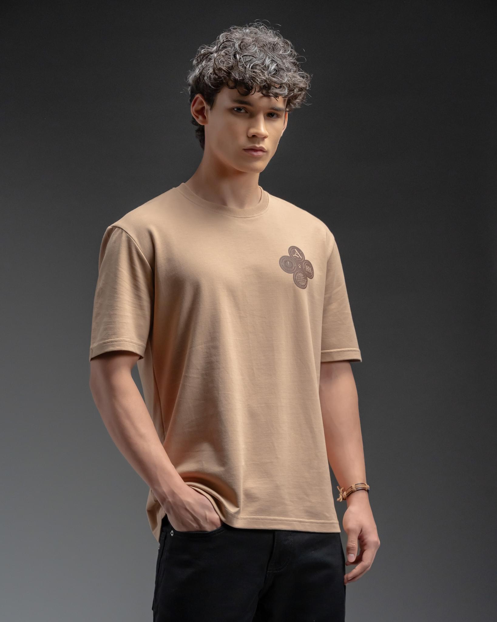 Snowpard Club Crest Relaxed Tee Desert Tan — model shot, premium men's graphic t-shirt