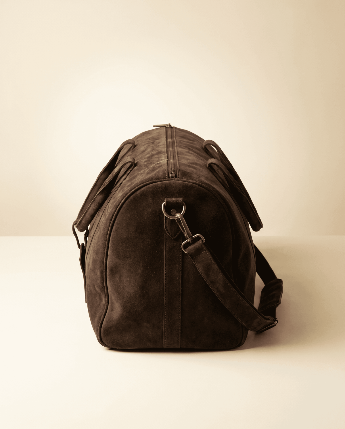 Snowpard embossed logo on Suru Duffel suede travel bag