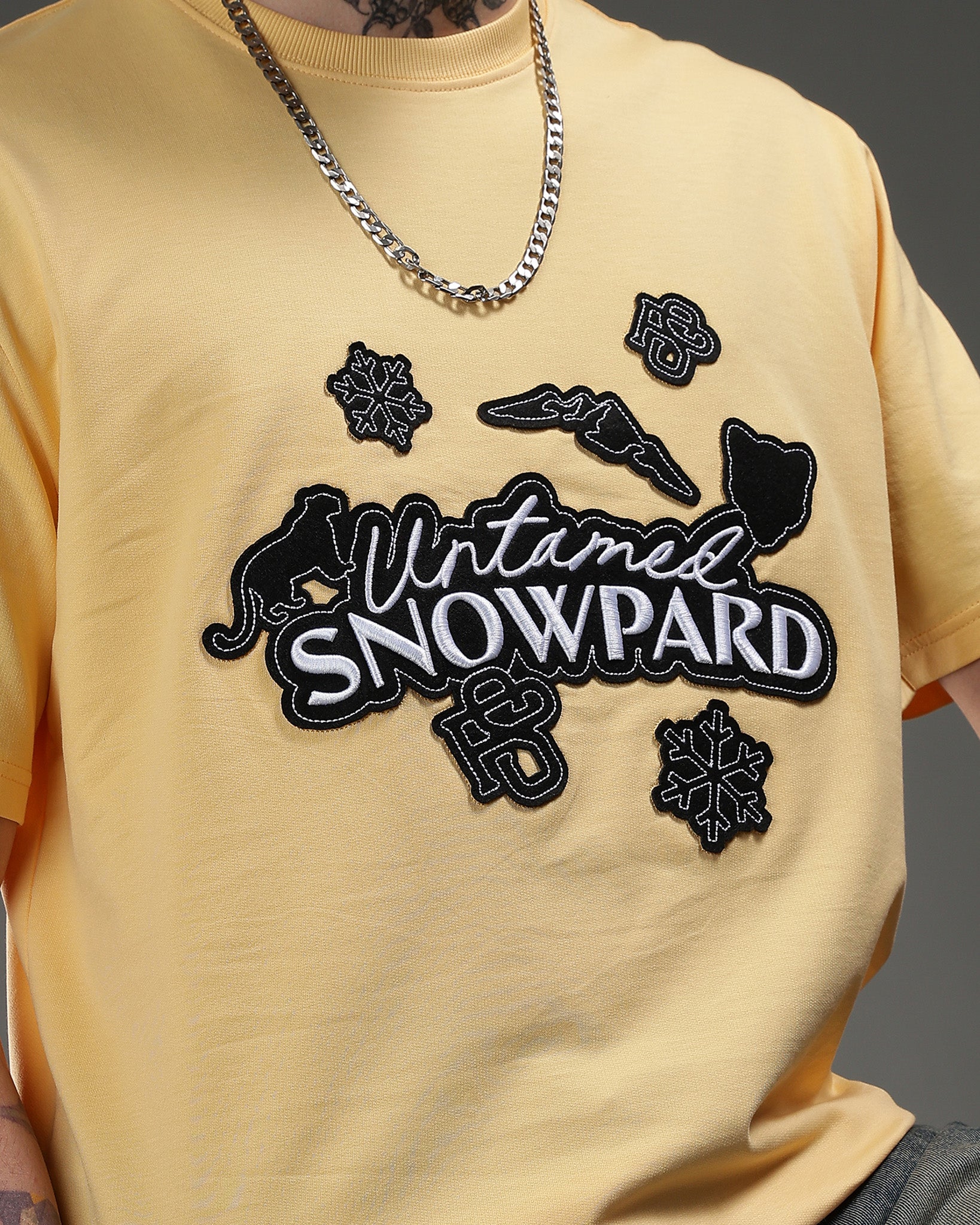Snowpard Yellow Icon Embroidered Tee Yellow — back view, layered high-density embroidered patches