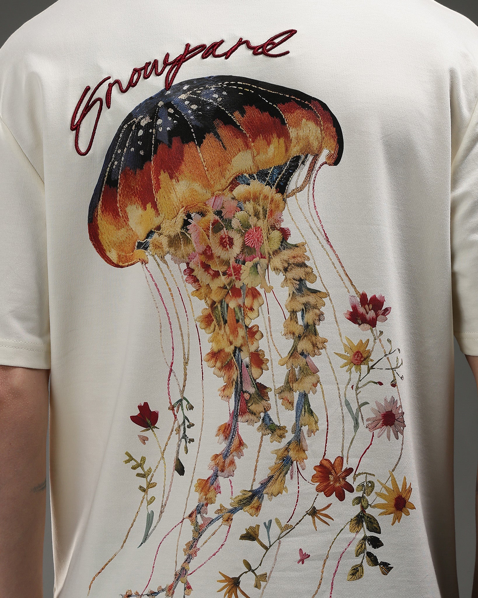 Snowpard Sting Hard Relaxed Tee Off White — back view, jellyfish floral 3D embroidery artwork