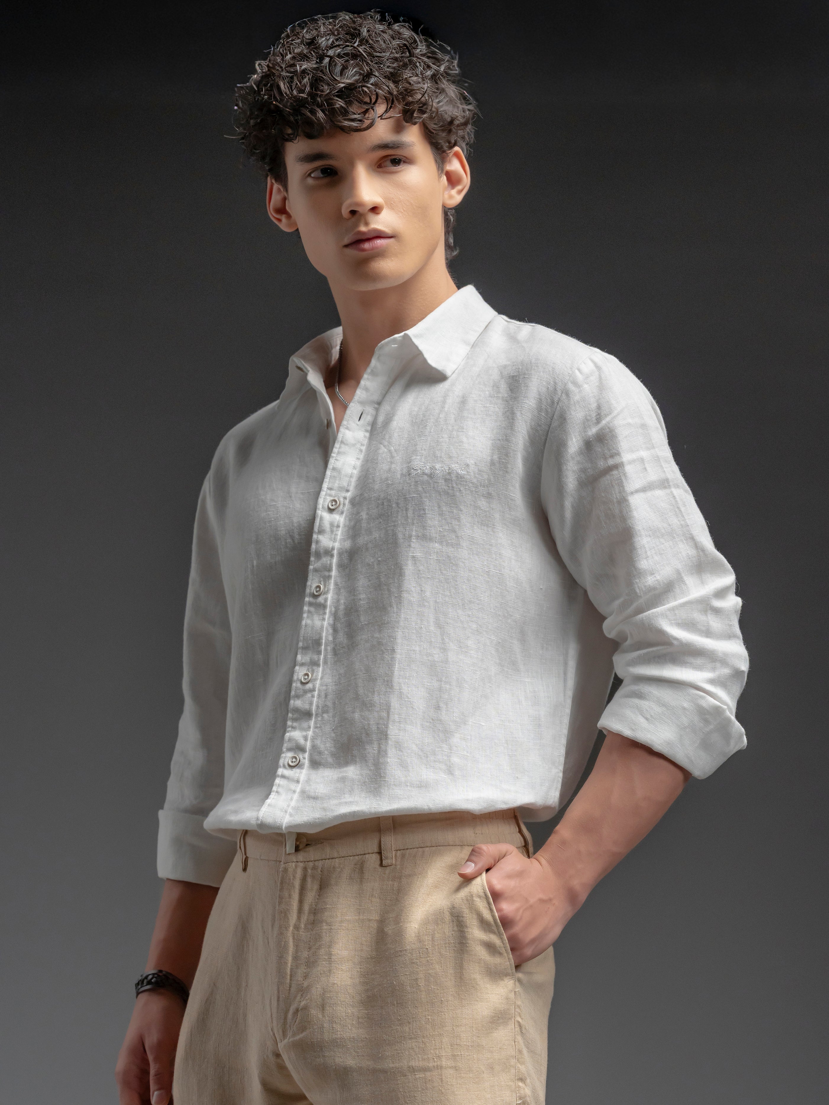 Man wearing a light-colored shirt and beige pants 