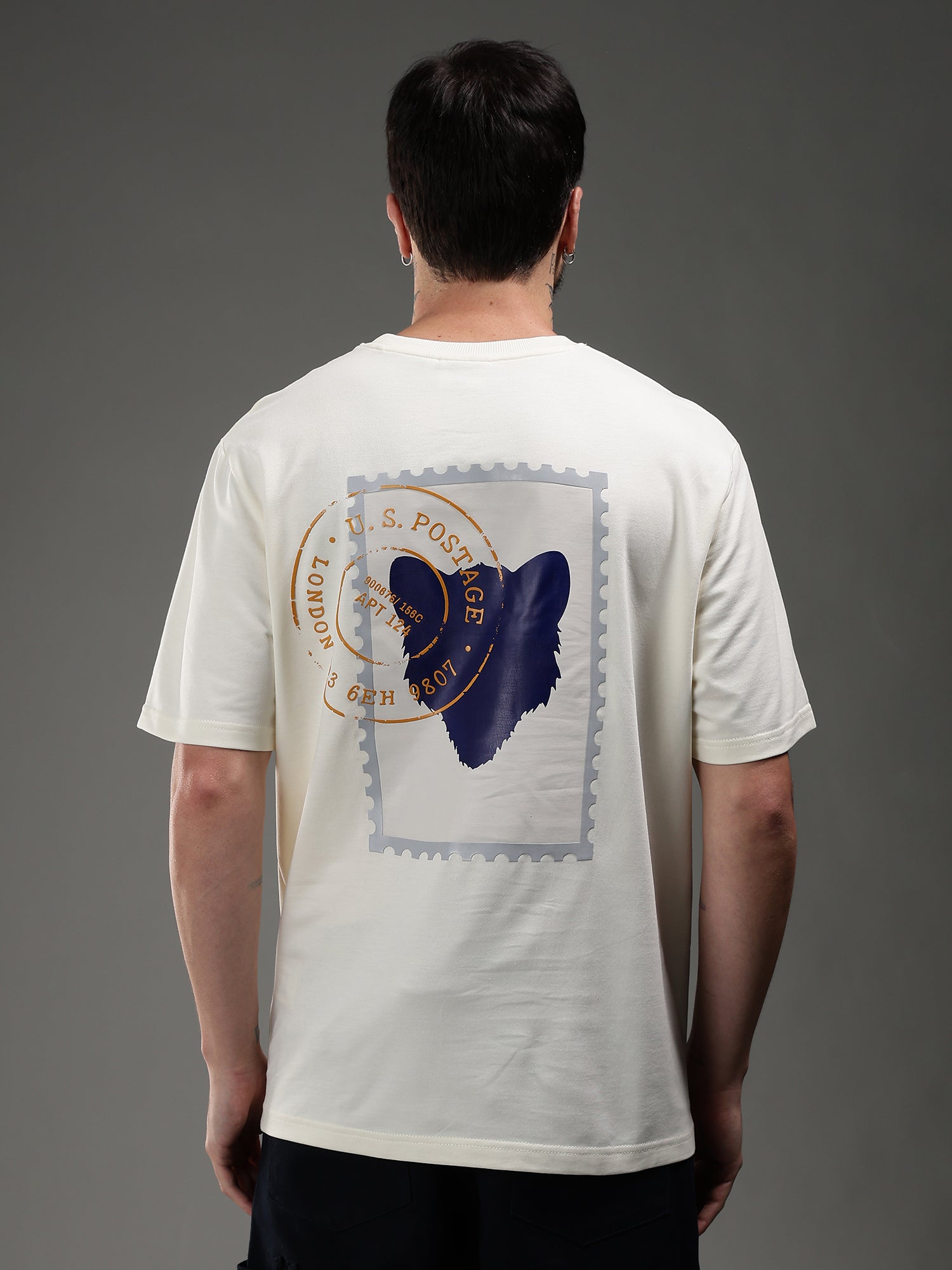 Person wearing a white t-shirt with a blue butterfly design on the back 