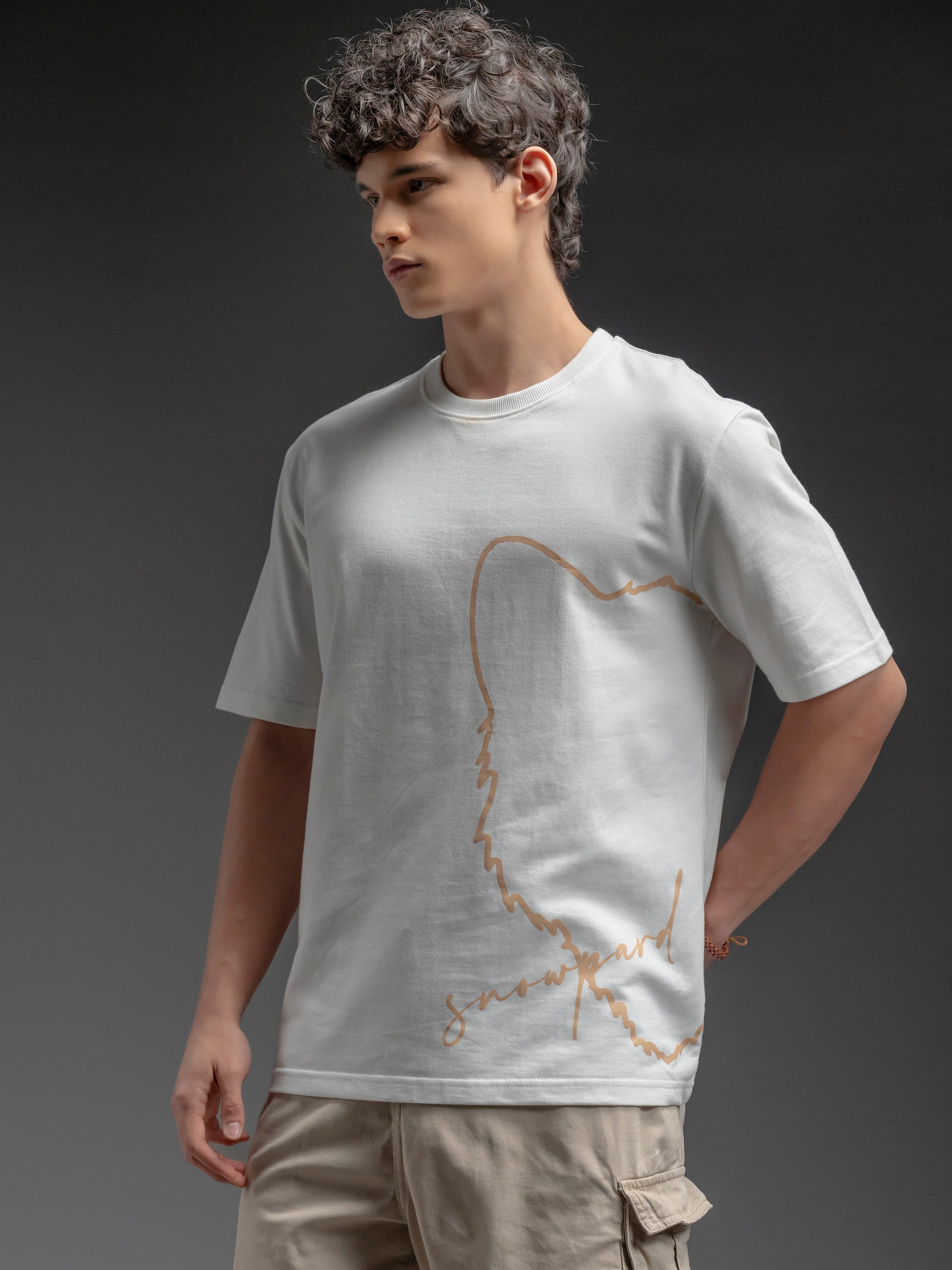 Person wearing a white t-shirt with a gold design