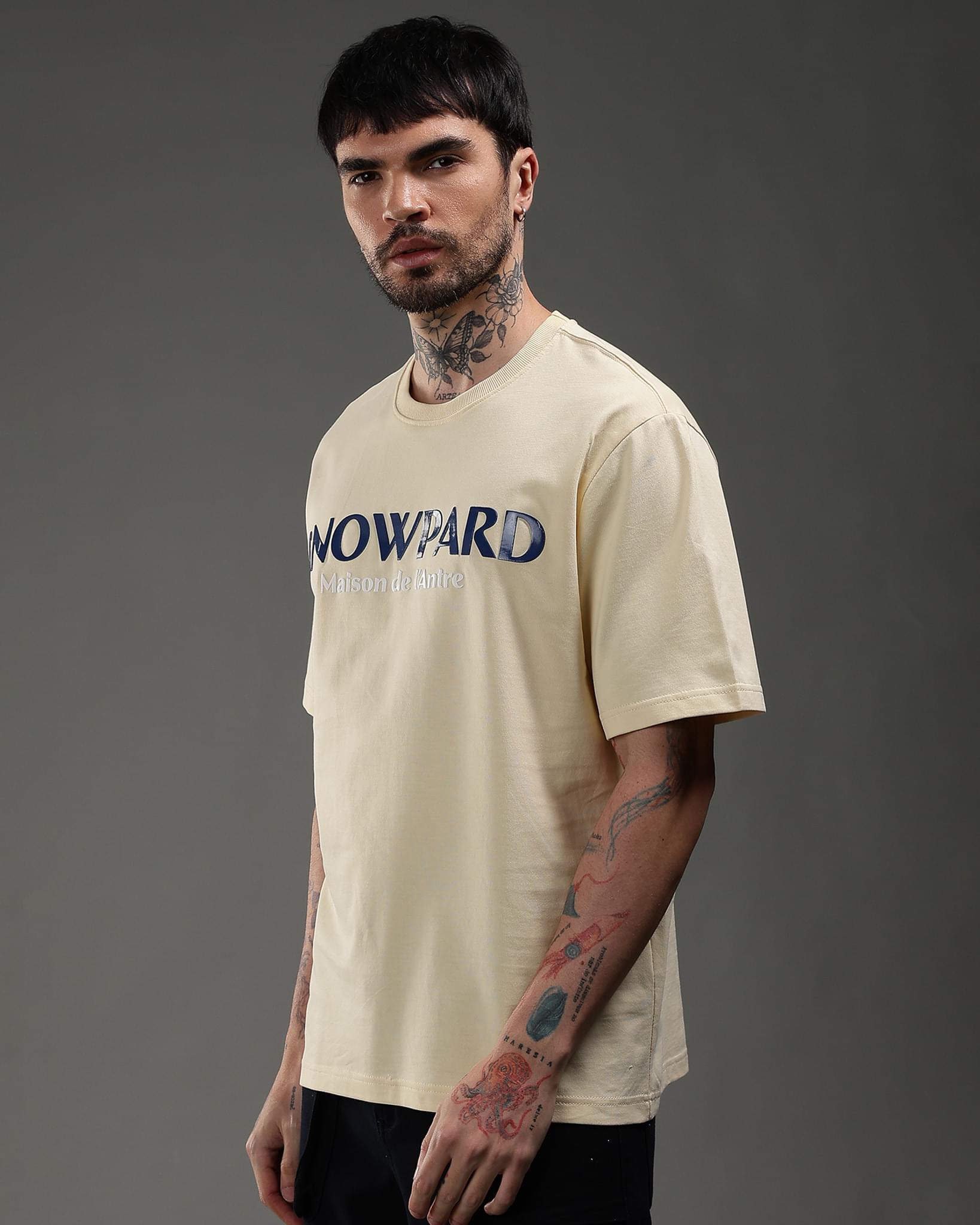 Snowpard Maison de l'Antre Relaxed Tee Beige — back view, bold SNOWPARD chest print