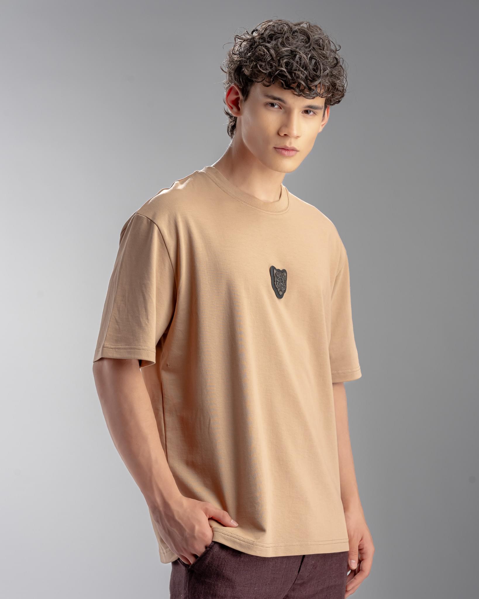 Snowpard Metal Badge Relaxed Tee Sand — back detail, clean sand base tee